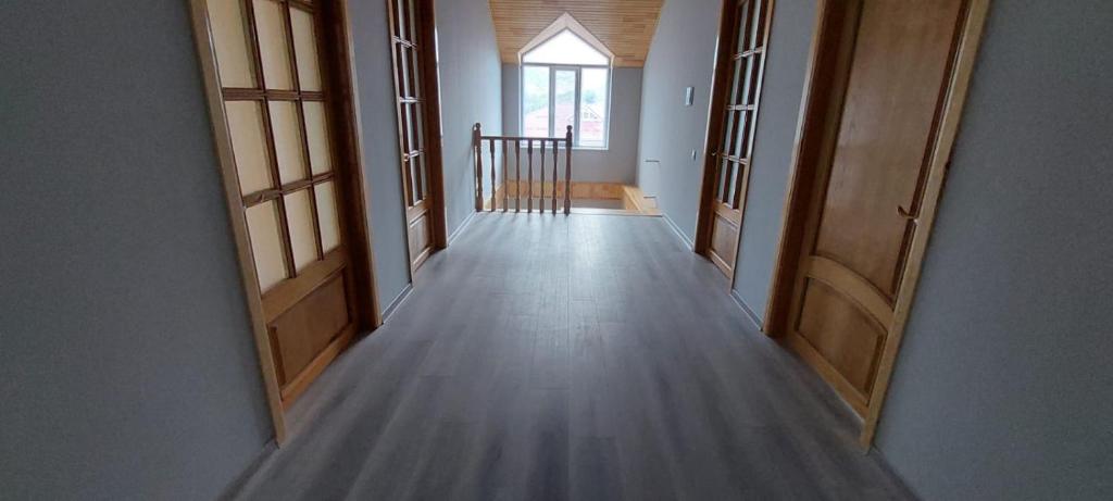 a hallway with two open doors in a house at Comfort Hills in İsmayıllı
