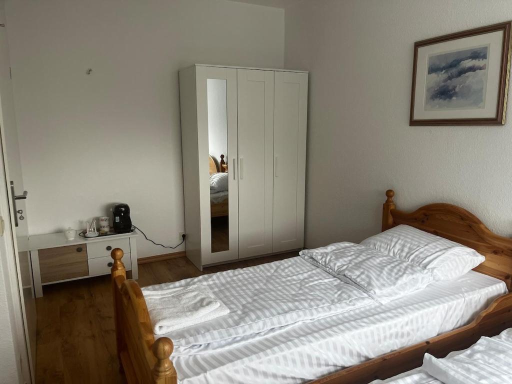 a bedroom with a bed and a mirror at Ferienwohnung Fatlume No 6 in Bad Honnef am Rhein