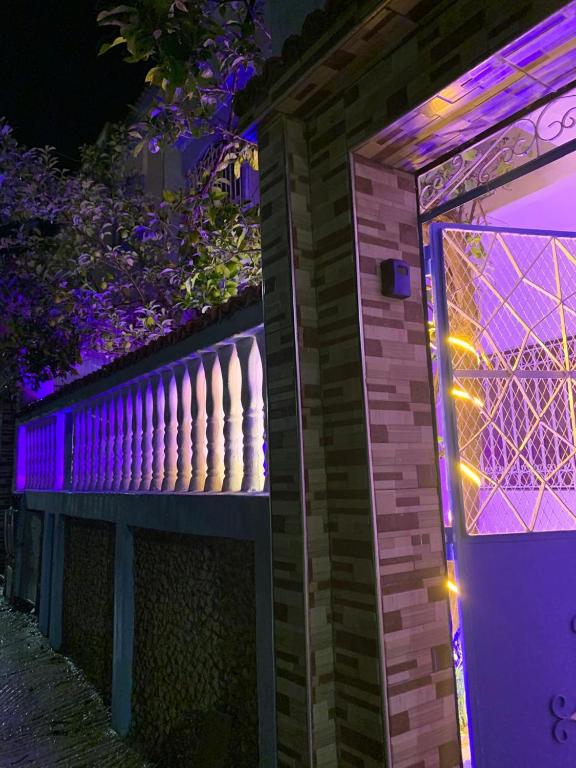 a house with purple lights on the side of it at velaris in Chefchaouen