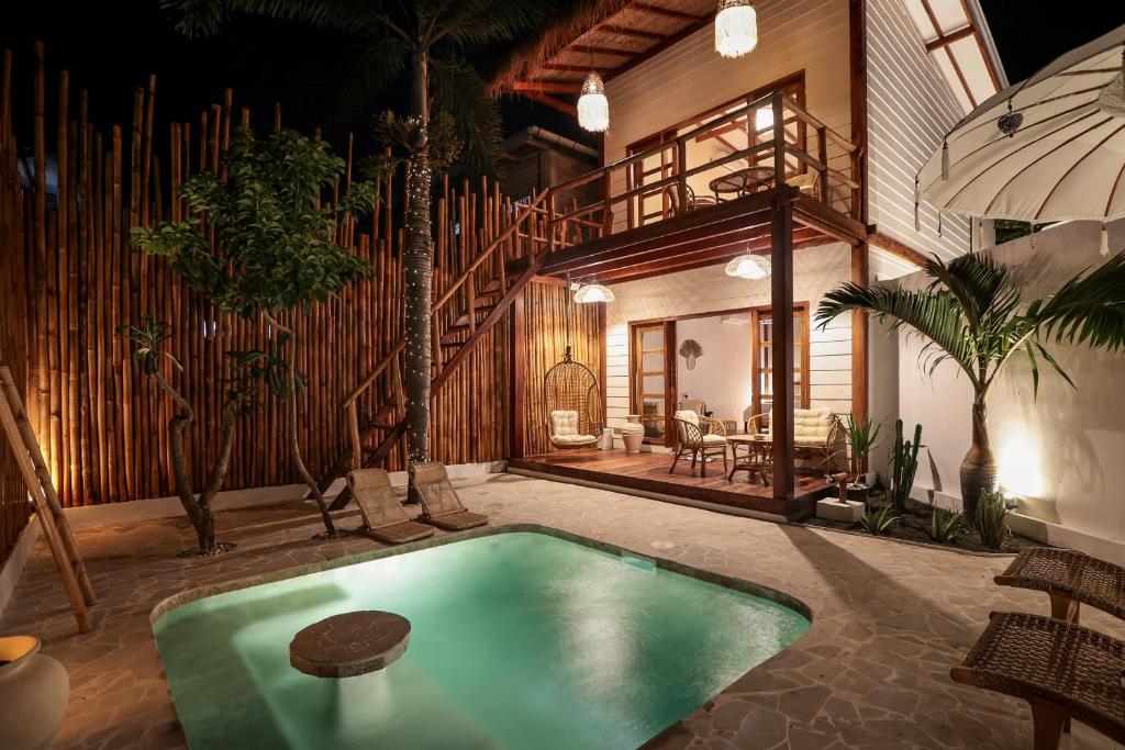 a swimming pool in the middle of a house at The Lost Island- Luxury Private Pool Villas in Gili Trawangan