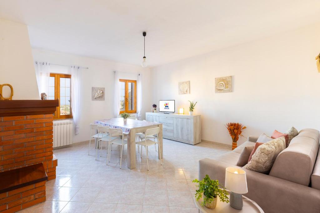 a living room with a couch and a table at Tavolara Ichnos House in San Teodoro