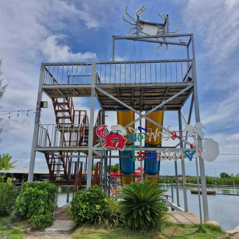 a metal structure with chairs and a water park at มีดี ฟาร์ม โฮมสเตย์ in Ban Klam