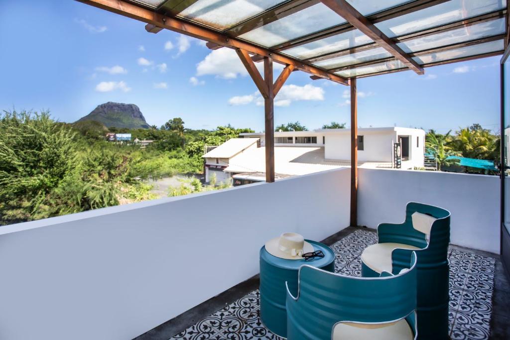 a view from the balcony of a house at Le Morne Base - Stylish, Pool & Rooftop in La Gaulette