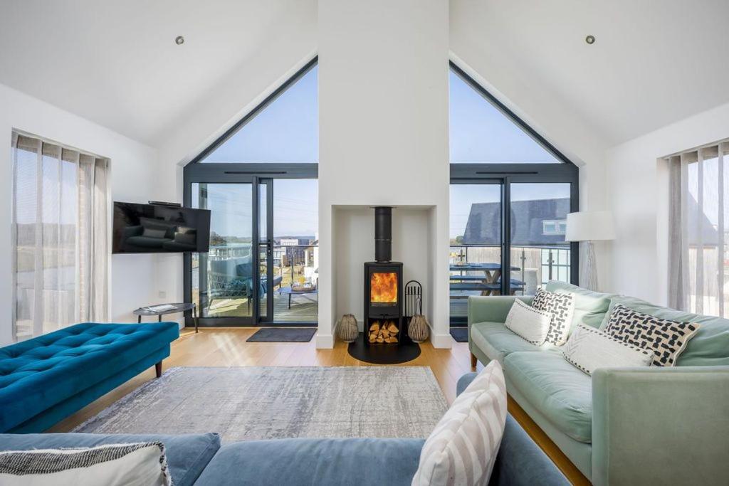 a living room with a couch and a fireplace at Jurassic in Dorchester