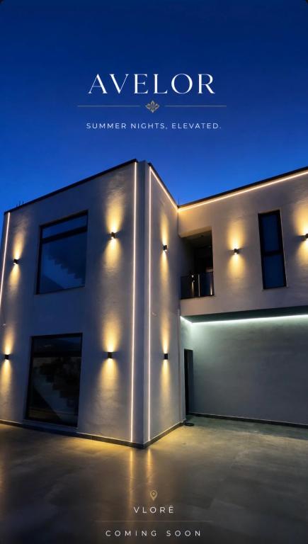 a building with lights on the side of it at Grand Avelor Hotel in Vlorë