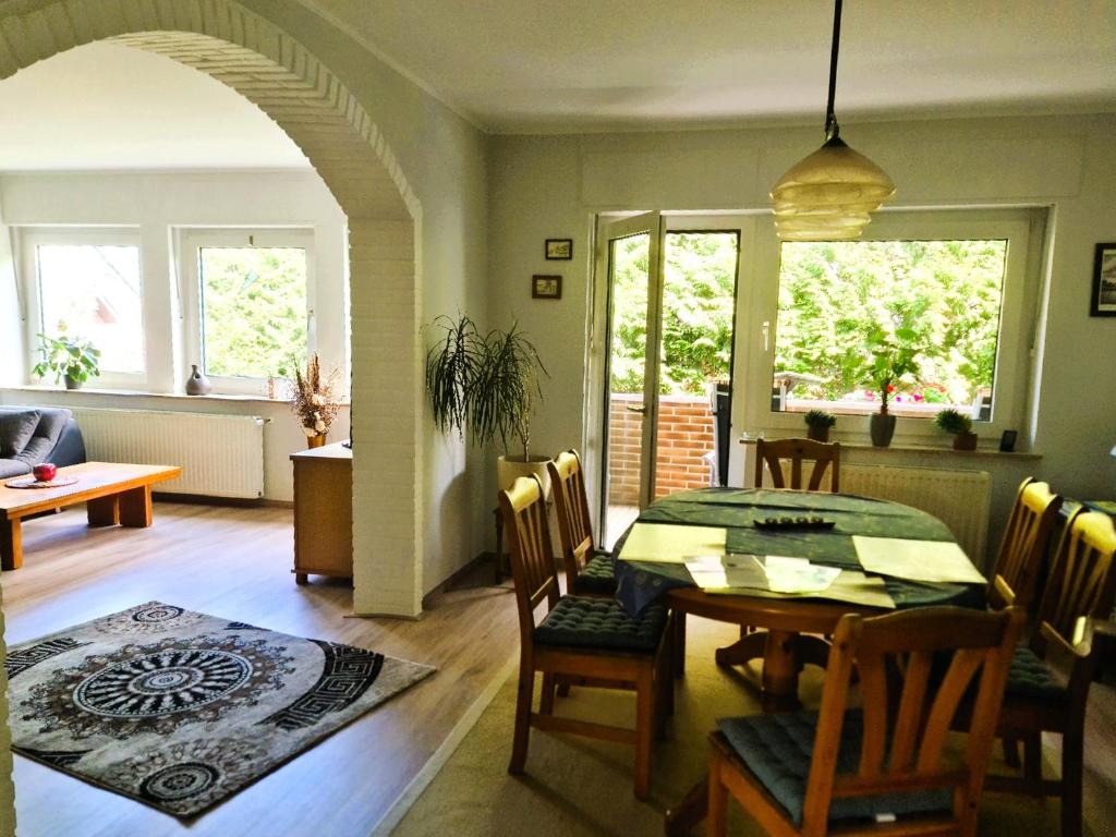 a dining room with a table and chairs and a room with at Ferienwohnung "Erika" Rees am Niederrhein in Rees