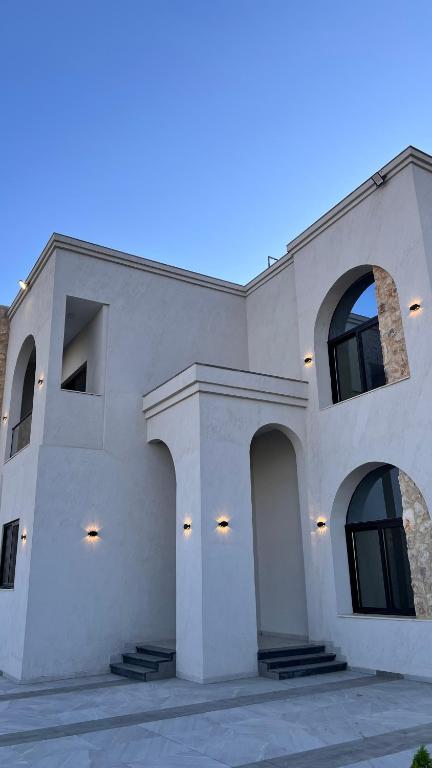a large white building with a lot of windows at ڤيلا الكرم in Jerash
