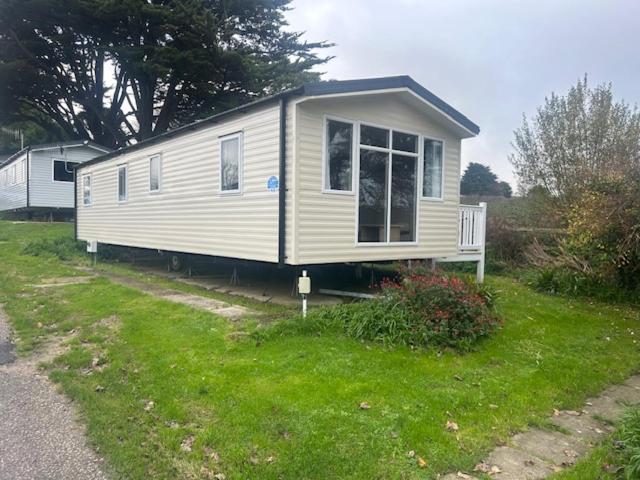 a tiny house sitting on top of a yard at Panacci Van - Weymouth Bay in Preston