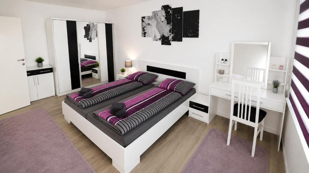 a bedroom with a large bed with purple pillows at Stan na dan Bosanska Krupa in Bosanska Krupa