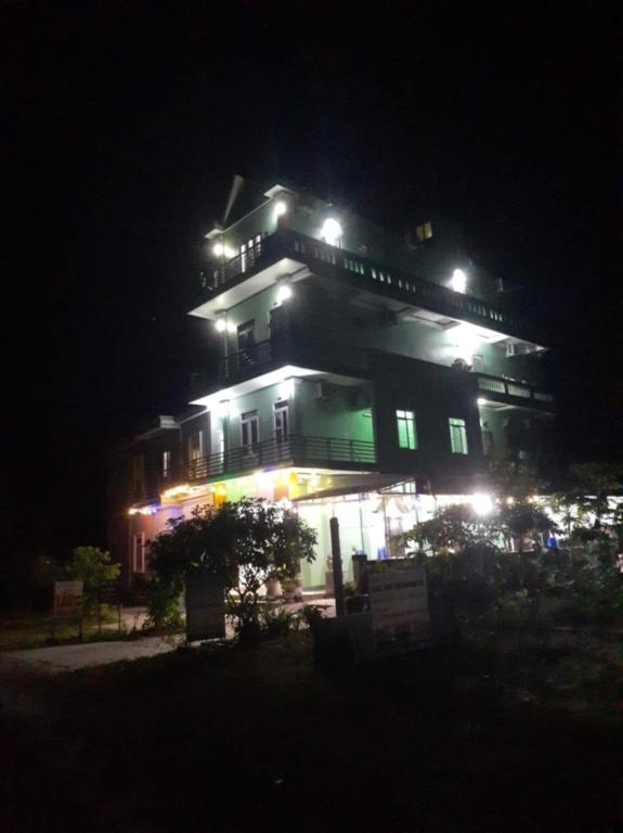 a large building with lights on it at night at Sơn Tùng House in Quang Ninh