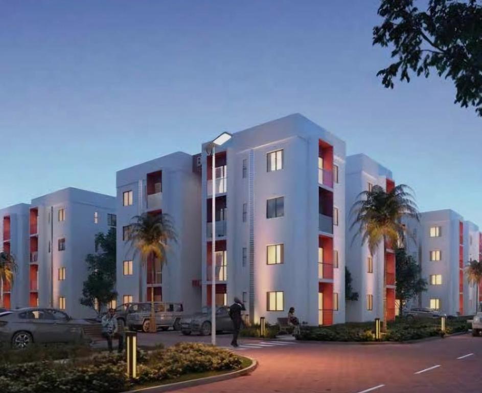 a man standing in a parking lot in front of a building at GL Luxe Suites in Tatu City