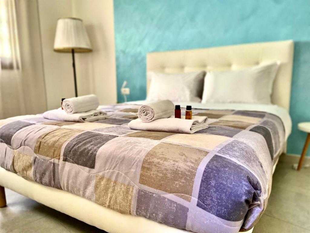 a bedroom with a large bed with towels on it at Ca' Gregolina in Venice