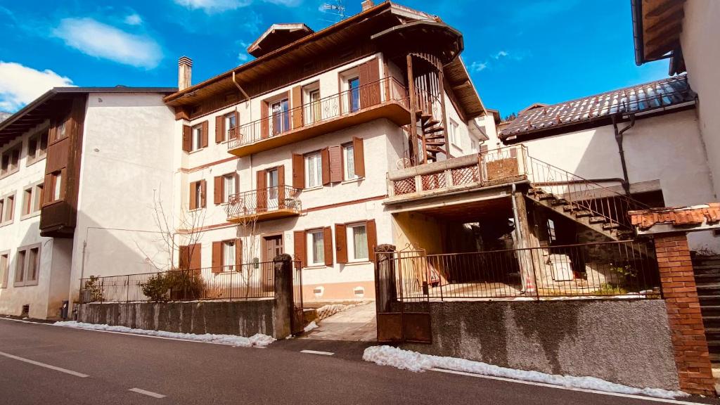 a building with balconies on the side of a street at villa Ada apartment in Cercivento