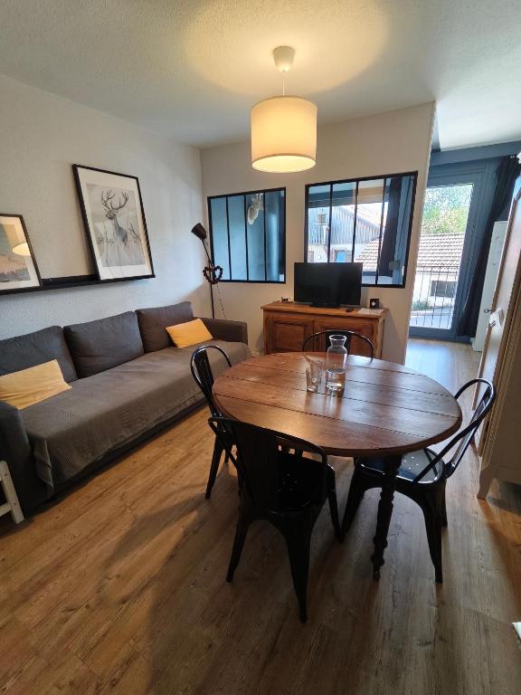 a living room with a table and a couch at La Mauselaine in Gérardmer
