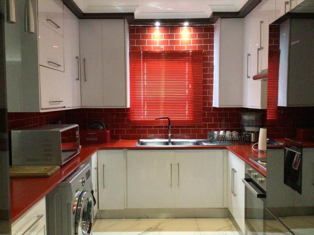 a kitchen with white cabinets and a sink at Private Secure house in Alberton in Alberton