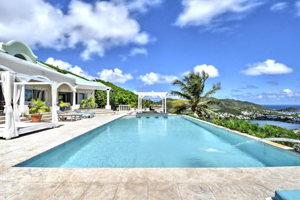 a swimming pool in the backyard of a villa at villa coralia - panoramic view in Saint Martin