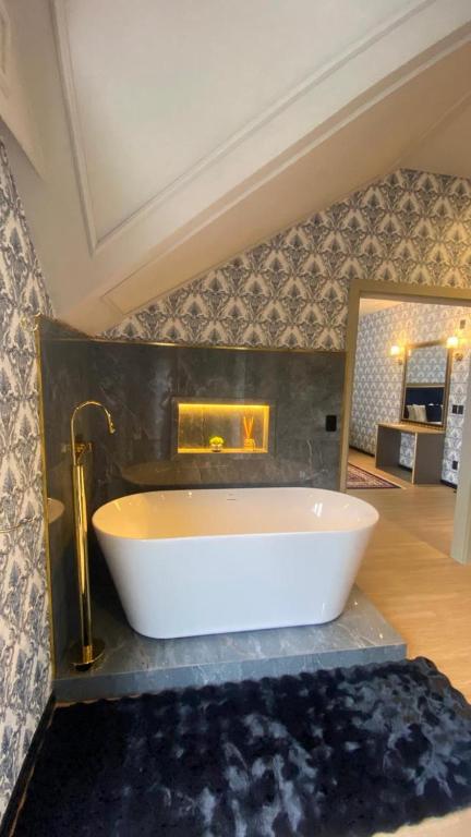 a bathroom with a white tub on a counter at Chalés e suítes vila verde in São Bento do Sul