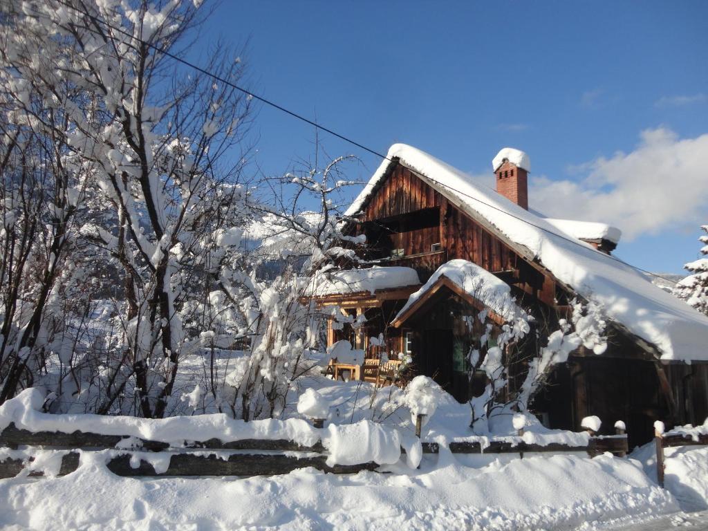 a log cabin covered in snow at Chalet Ramsau 8 in Bad Goisern