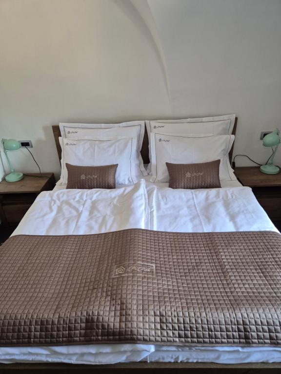 a bedroom with a large bed with two pillows at Apartmaji Pr'Pišk in Bohinjska Bela