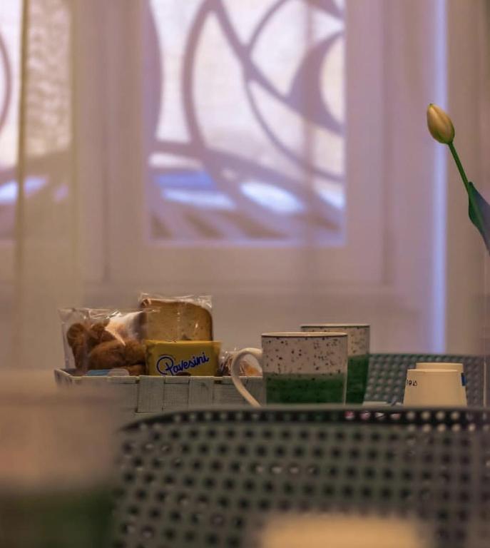 a table with a tray of food and a flower at B&B in centro in Eboli