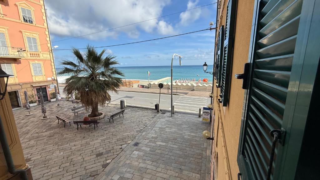 a view of the beach from a window of a building at Appartamento piazza Buccelli a 10 mt dal mare in Varazze