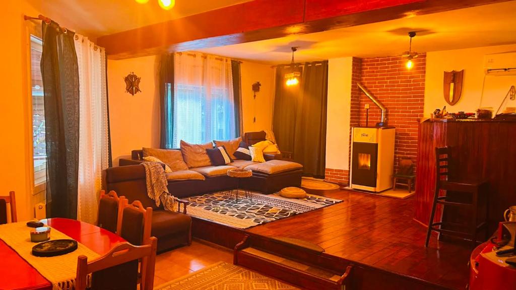 a living room with a couch and a table at OLD SHEPHERD Guest House in Râșca