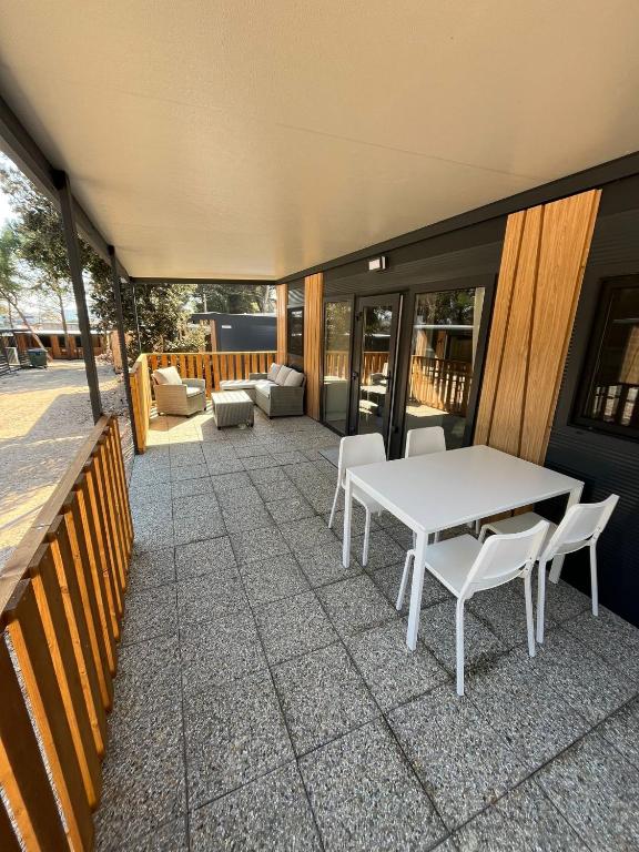 a white table and chairs on a patio at Emil 8 in Pakoštane