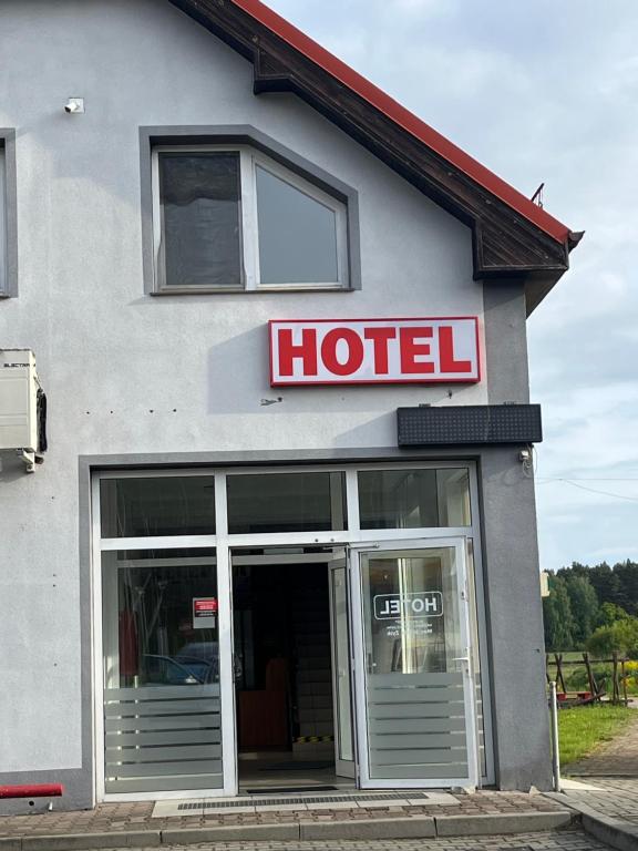 a hotel sign on the side of a building at Noclegi Królów in Królów