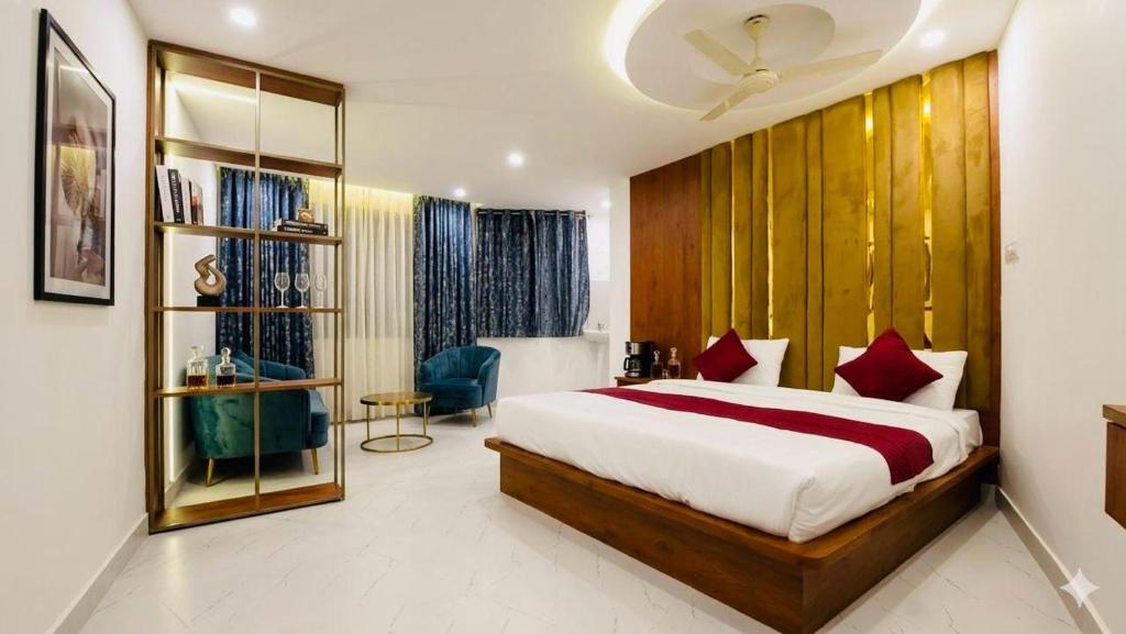 a bedroom with a large bed in a room at hotel ak grand in Mangalore