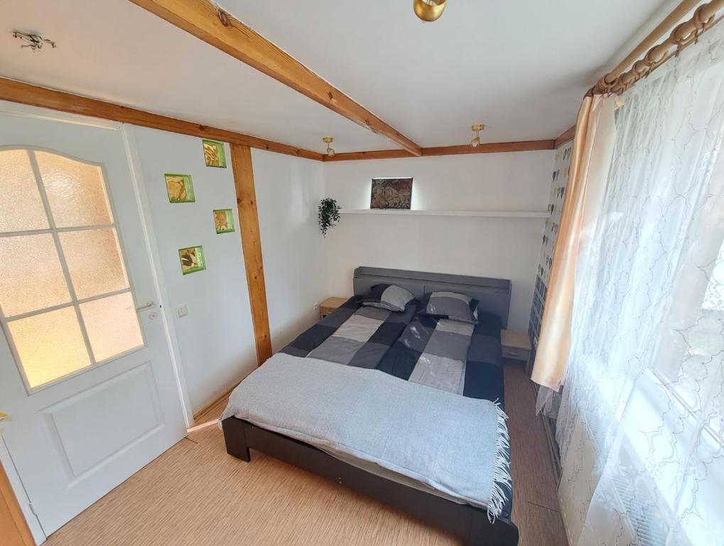 a small bedroom with a bed and a window at Peaceful Cottage With Garden in Saulkrasti