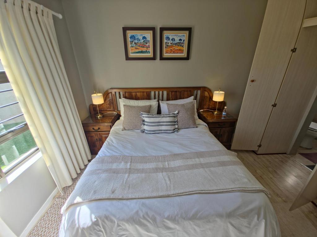 a bedroom with a bed with pillows and a window at Caledonia Guest Room in Trichardt