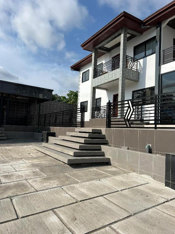 a building with stairs in front of a building at T&J Harmony Lodge in Limbe