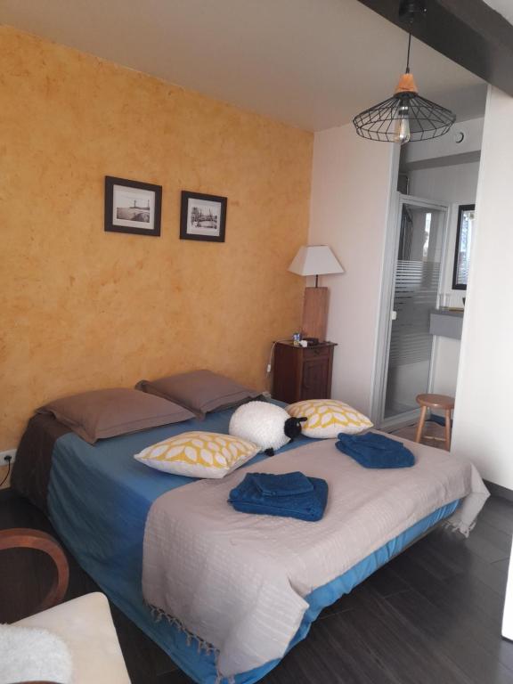 a bedroom with two beds with blue towels on them at Chez Is-Mi in Chauriat