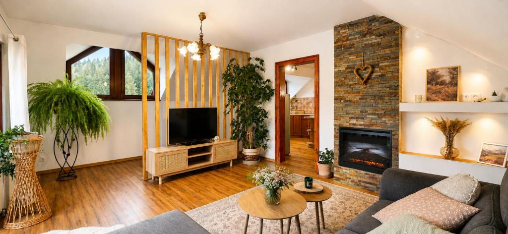 a living room with a couch and a fireplace at Apartmán pod Skalou in Vysoká nad Kysucou
