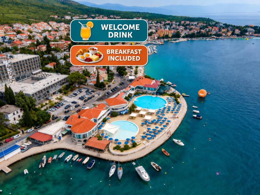 a view of a resort with boats in the water at Hotel Millenium deluxe in Selce