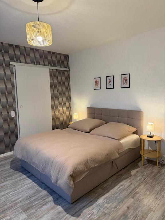 a bedroom with a large bed and two tables at Dianas Ferienwohnung 1 in Feldberg