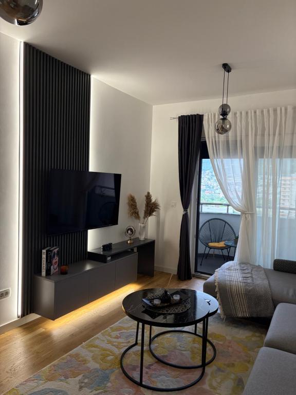 a living room with a couch and a table at Sarah Central City Apartment-Bar in Bar