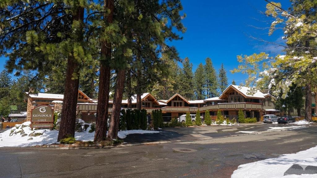 a large wooden house with snow in front of it at Gondola Lodge with Free Beach Voucher in South Lake Tahoe