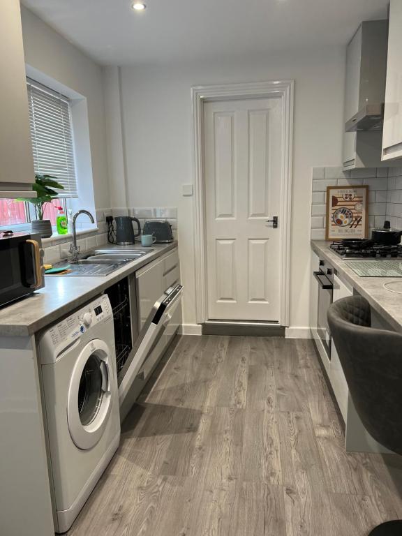 a kitchen with a washer and dryer in it at Central Kettering Apartment by SJP Ideal for up to 3 Guests in Kettering