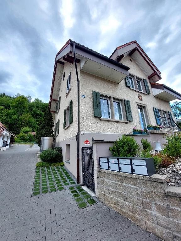 a house with a gate in front of it at Viktoria's B&B in Unterkulm