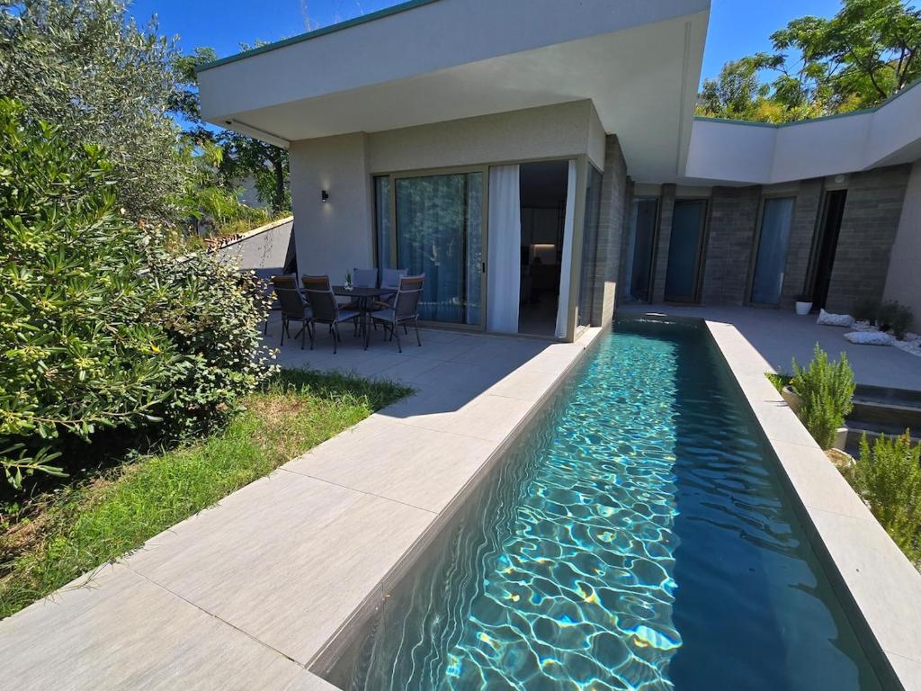 a swimming pool in the backyard of a house at SunkissedVilla in Draç