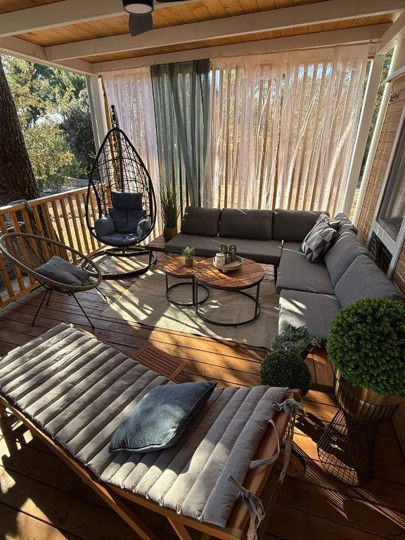 a screened in porch with a couch and chairs at Mobile Home LOREN in Biograd na Moru