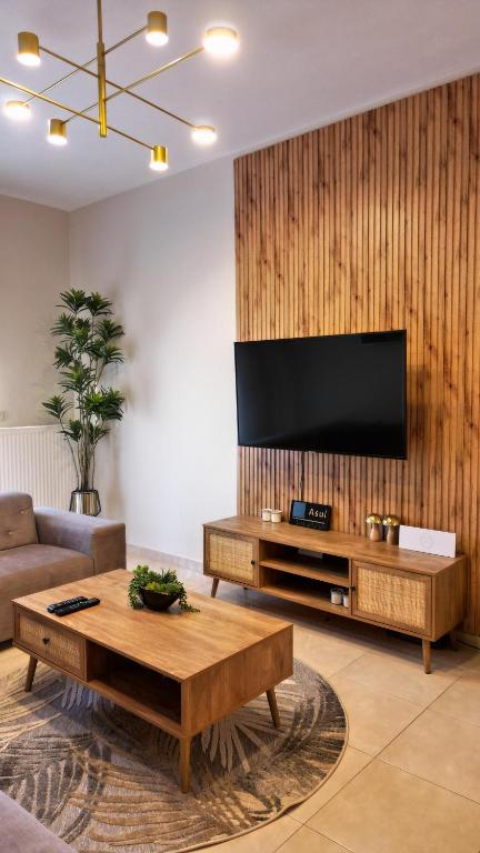 a living room with a flat screen tv on a wall at Asul Seaside Retreat in Stavros