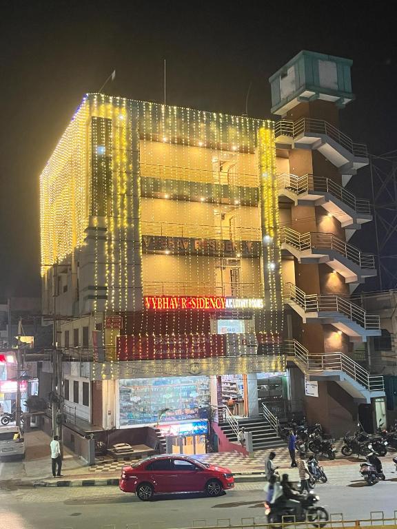 a large building with lights on it at night at Vybhav Residency in Anantapur