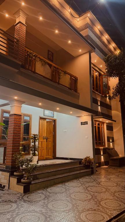a house with a staircase leading to the front door at Arackal in Trivandrum