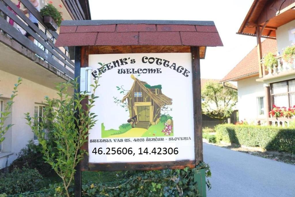 a sign for a cottage in a yard at Frenkcottage 5 KM FROM THE AIRPORT- FREE TRANSPORTATION TO THE AIRPORT in Šenčur
