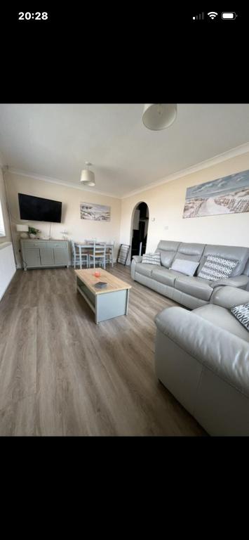 a large living room with couches and a table at Saddlebrook 156 in Leysdown-on-Sea