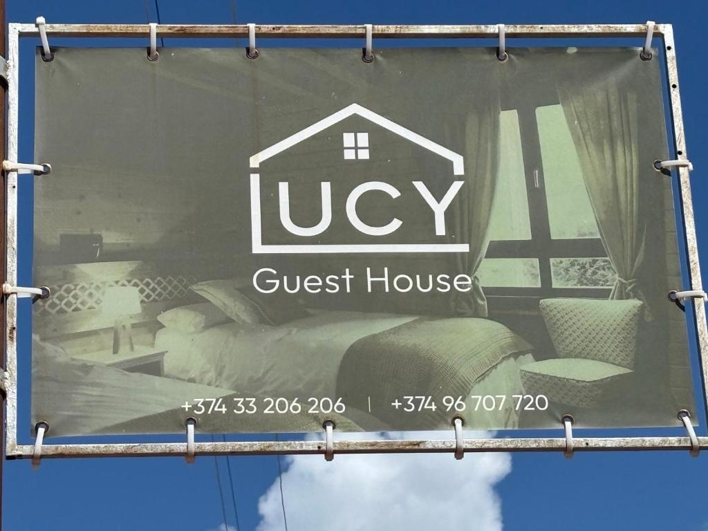 a guest house sign on a window of a guest house at Rob Guest House in Garni