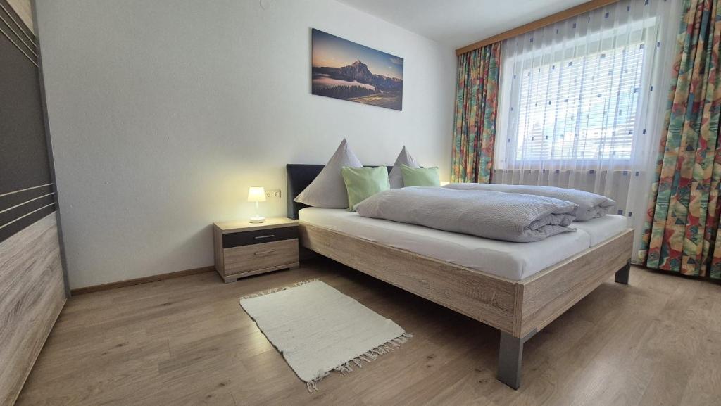 a bedroom with a bed and a window at Ferienwohnung Sonnweber in Stanzach