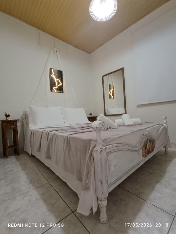 a bedroom with a large white bed in a room at GIATRELOS HOUSE "near the shipwreck Zakynthos" in Volímai